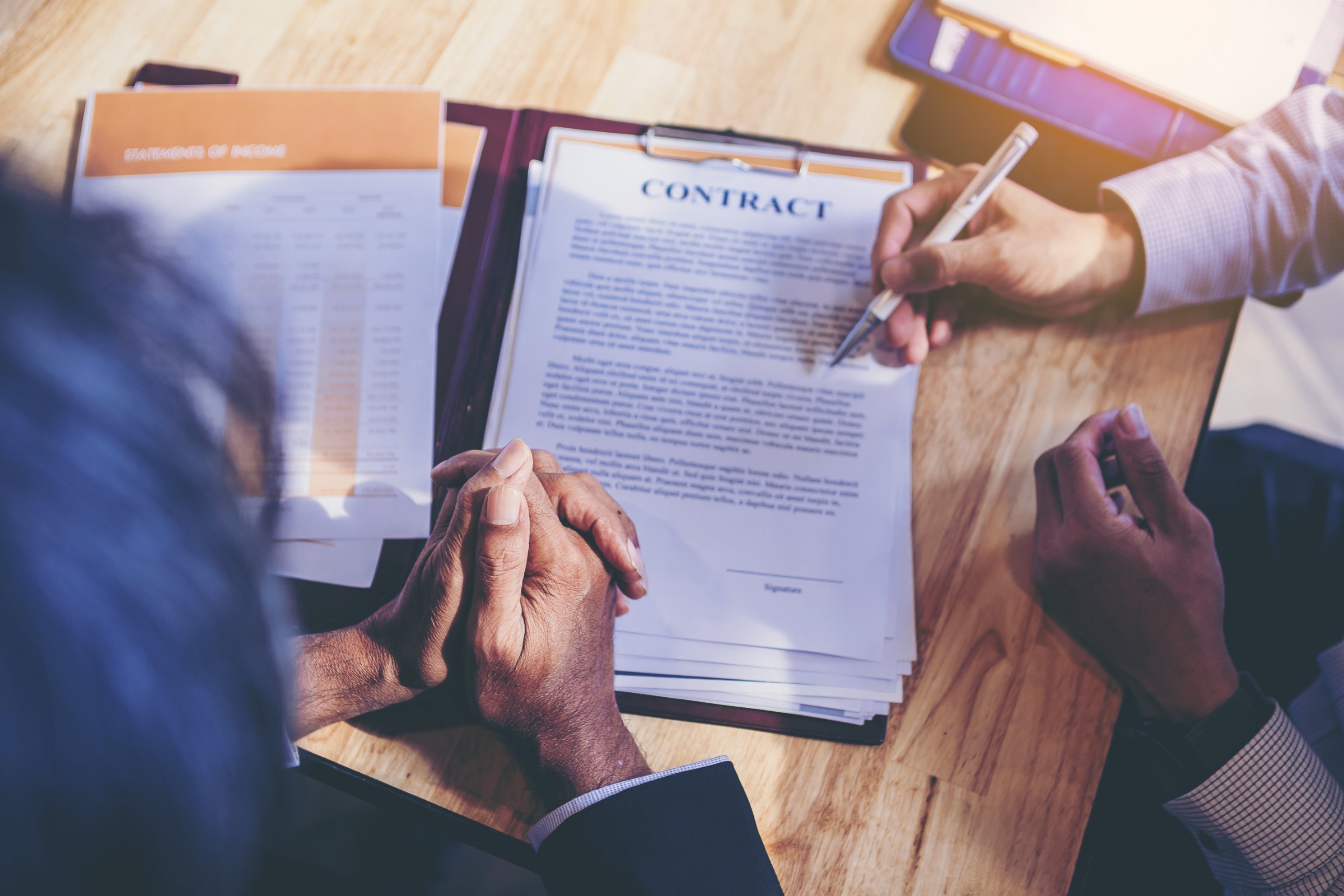 A man reading the terms of an employment contract before signing