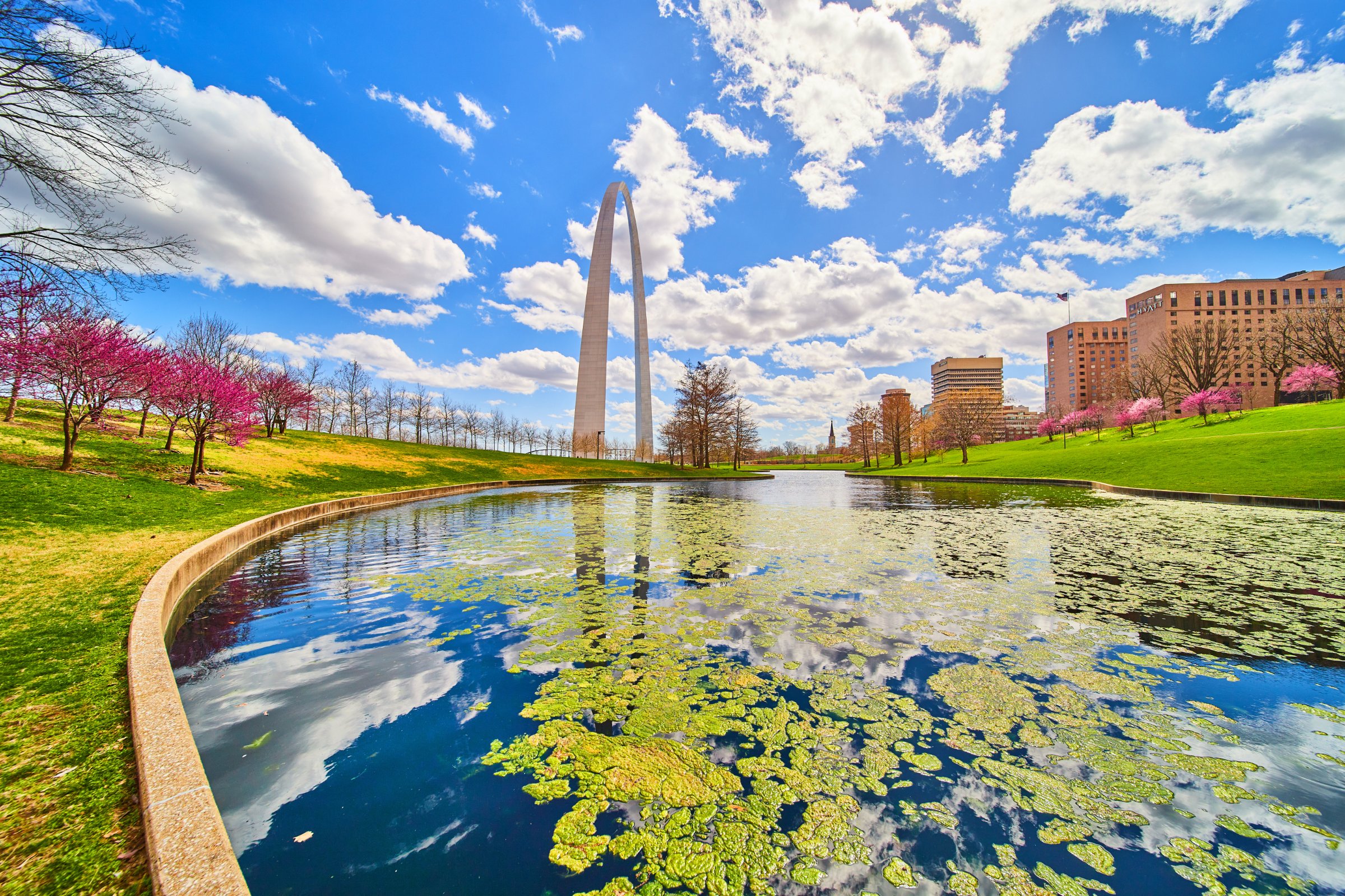 The Gateway Arch in St. Louis reflected in a pond in spring